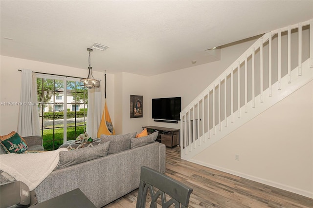 2750 SW 81st Ave Unit 1202, Miramar, FL 33025 - living room with wood finished floors, stairs, a chandelier, and baseboards