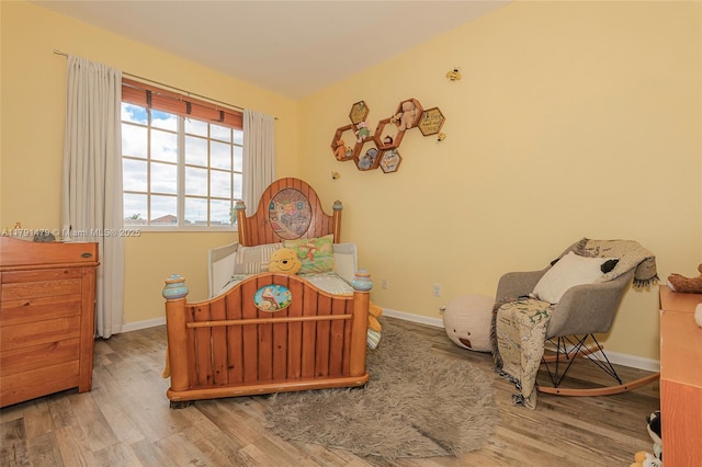 bedroom featuring baseboards and wood finished floors