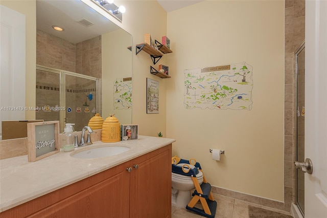 bathroom featuring tile patterned floors, vanity, toilet, and a shower stall