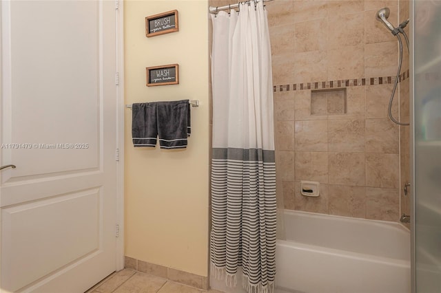 bathroom featuring shower / bath combination with curtain, baseboards, and tile patterned floors