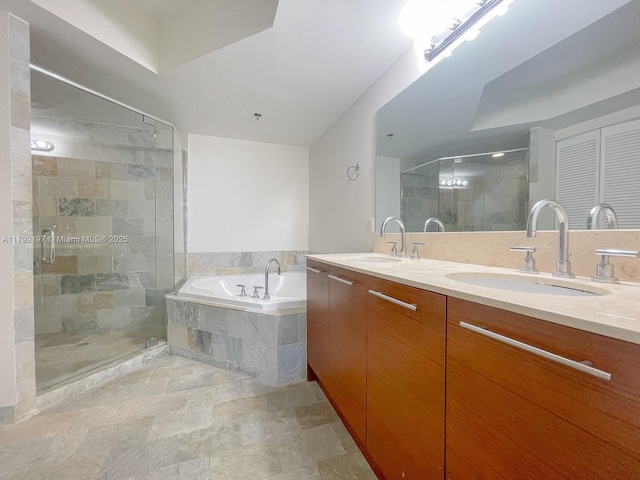 bathroom with a shower stall, a bath, double vanity, and a sink