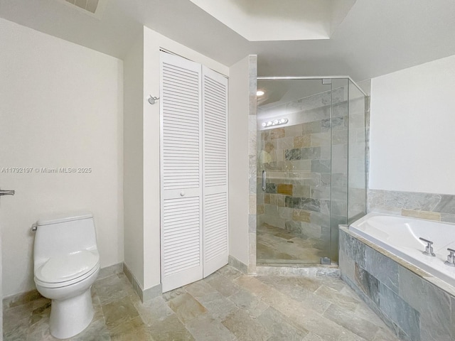bathroom with stone tile flooring, a closet, a shower stall, and a bath