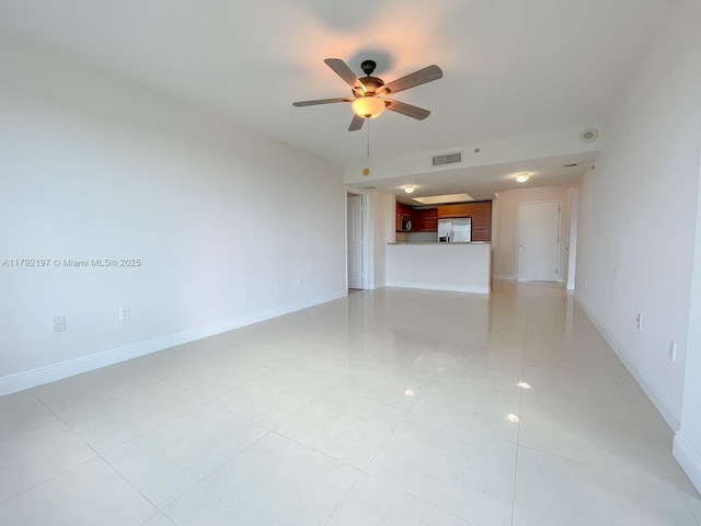 unfurnished living room with a ceiling fan, baseboards, light tile patterned floors, and visible vents