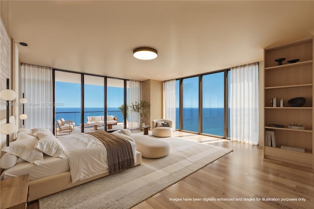 bedroom featuring a wall of windows, a water view, wood finished floors, and access to exterior