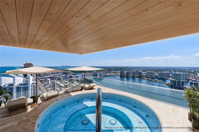 view of pool with a city view, a hot tub, a water view, and central air condition unit