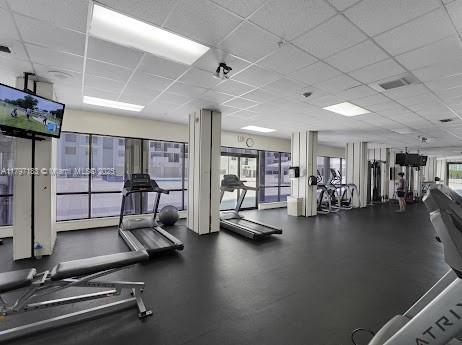workout area featuring a paneled ceiling