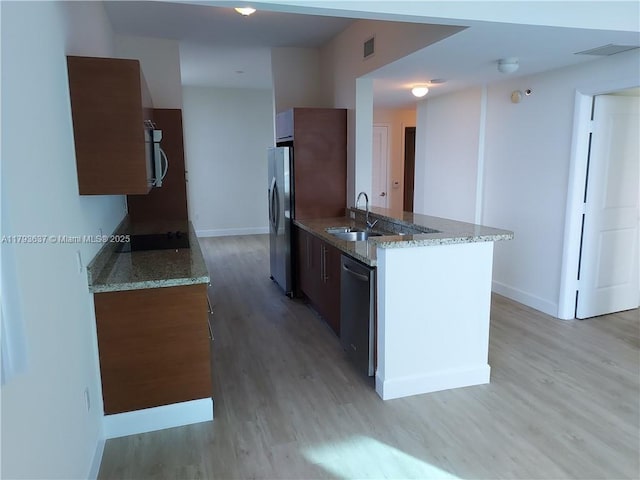 2641 N Flamingo Rd Unit 307N, Sunrise, FL 33323 - kitchen with stainless steel appliances, a sink, light wood-type flooring, and baseboards