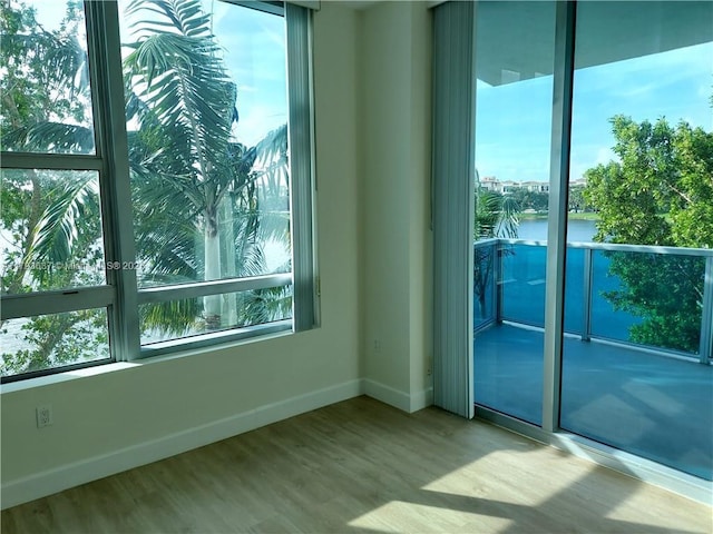2641 N Flamingo Rd Unit 307N, Sunrise, FL 33323 - unfurnished room featuring baseboards, a water view, and wood finished floors