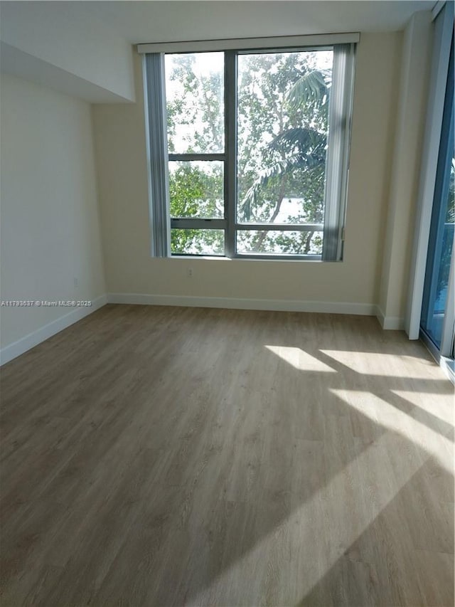 2641 N Flamingo Rd Unit 307N, Sunrise, FL 33323 - unfurnished room with baseboards and wood finished floors