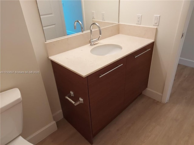 2641 N Flamingo Rd Unit 307N, Sunrise, FL 33323 - half bathroom featuring vanity, wood finished floors, baseboards, and toilet