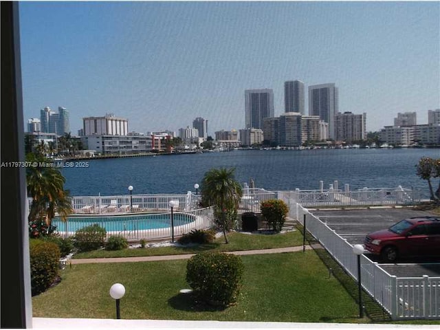 view of water feature featuring fence and a city view