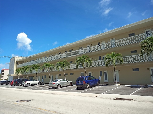 view of building exterior featuring uncovered parking