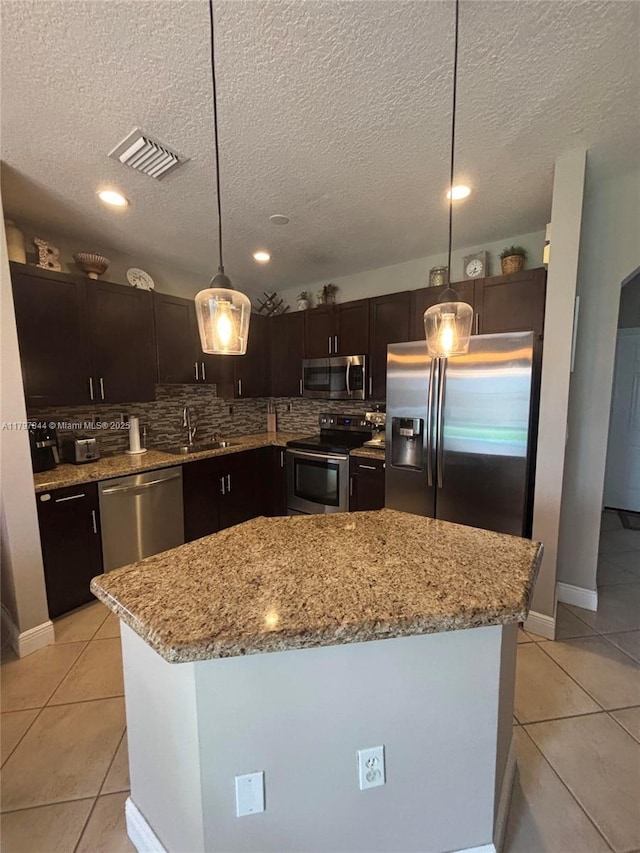 kitchen featuring decorative backsplash, light tile patterned floors, visible vents, and appliances with stainless steel finishes