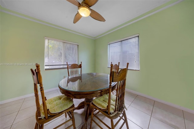 dining area with light tile patterned floors, a ceiling fan, and plenty of natural light