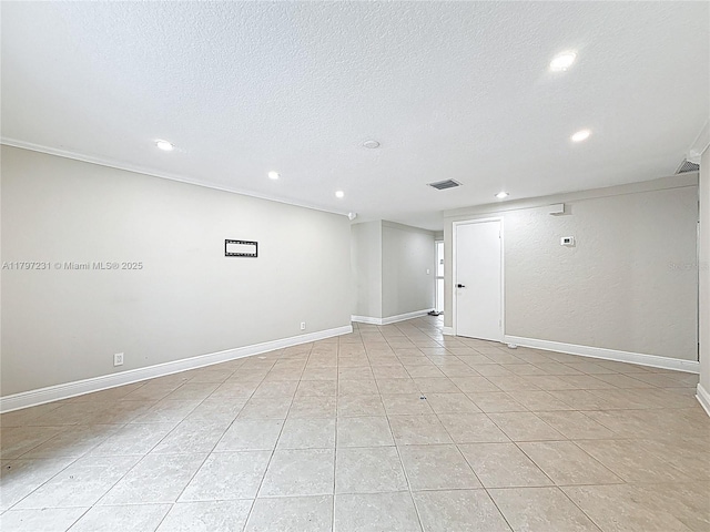 unfurnished room with a textured ceiling, visible vents, light tile patterned floors, and recessed lighting