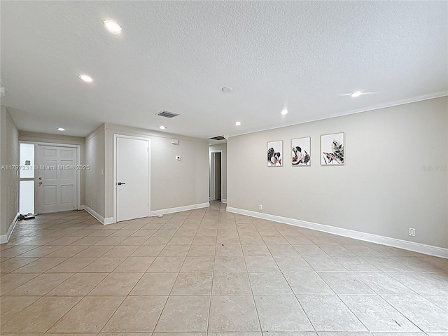interior space with a textured ceiling, visible vents, baseboards, light tile patterned flooring, and recessed lighting