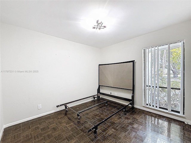 unfurnished room featuring baseboards