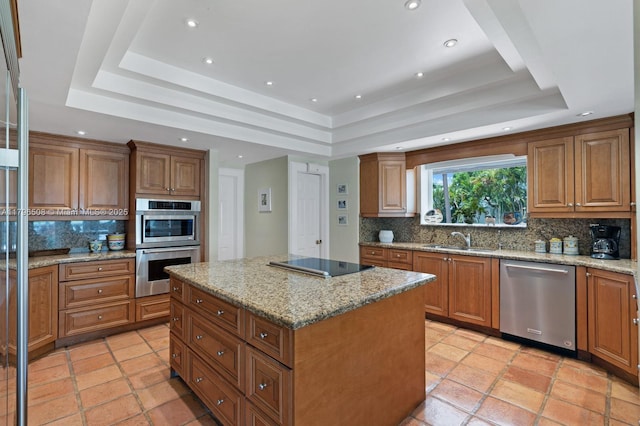 10301 E Broadview Dr, Bay Harbor Islands, FL 33154 - kitchen with stainless steel appliances, a tray ceiling, a sink, tasteful backsplash, and recessed lighting