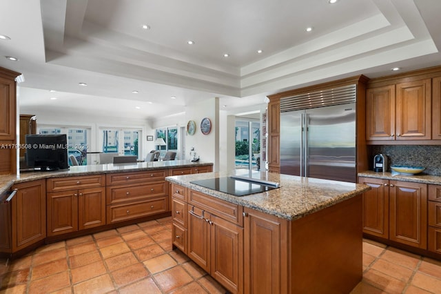 10301 E Broadview Dr, Bay Harbor Islands, FL 33154 - kitchen featuring stainless steel built in fridge, a tray ceiling, black electric stovetop, and recessed lighting
