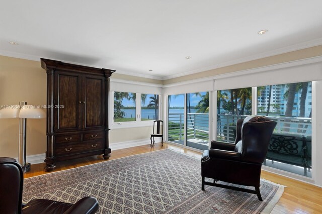 10301 E Broadview Dr, Bay Harbor Islands, FL 33154 - sitting room with light wood-style floors, baseboards, ornamental molding, a water view, and recessed lighting
