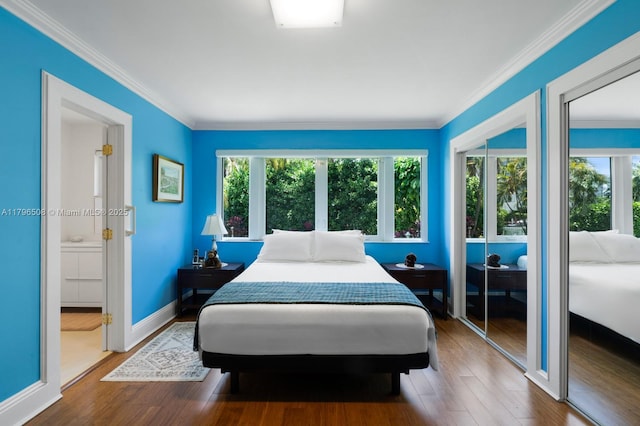10301 E Broadview Dr, Bay Harbor Islands, FL 33154 - bedroom with multiple windows, wood finished floors, crown molding, multiple closets, and baseboards
