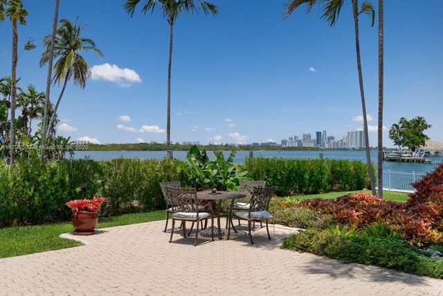 10301 E Broadview Dr, Bay Harbor Islands, FL 33154 - view of patio / terrace with a water view and outdoor dining space
