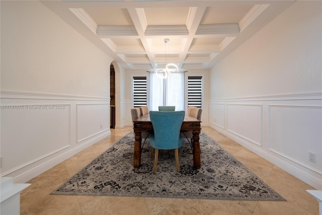 dining area featuring a decorative wall, coffered ceiling, beamed ceiling, and arched walkways