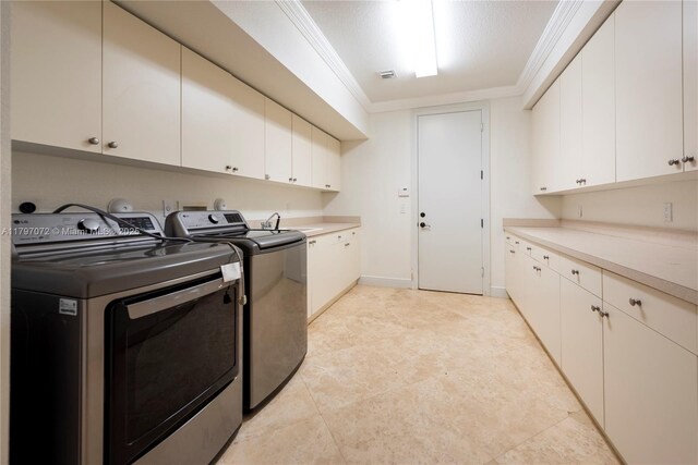 laundry room featuring ornamental molding, washer and dryer, a sink, and cabinet space