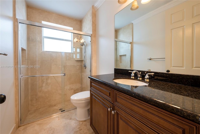 bathroom with vanity, toilet, a shower stall, and crown molding