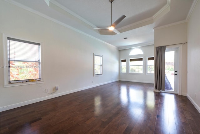 empty room featuring a ceiling fan, ornamental molding, dark wood finished floors, and baseboards