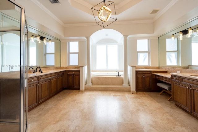 full bath with visible vents, a sink, a garden tub, two vanities, and ornate columns