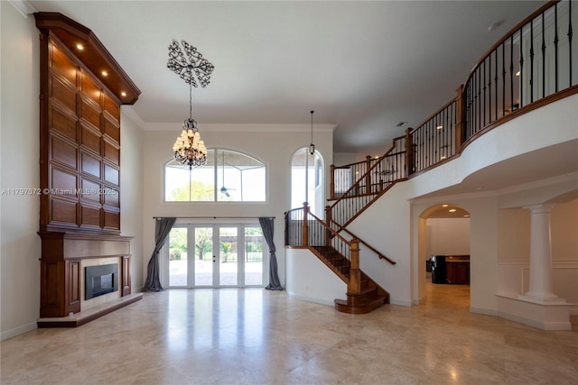 unfurnished living room featuring french doors, baseboards, stairs, a towering ceiling, and a large fireplace