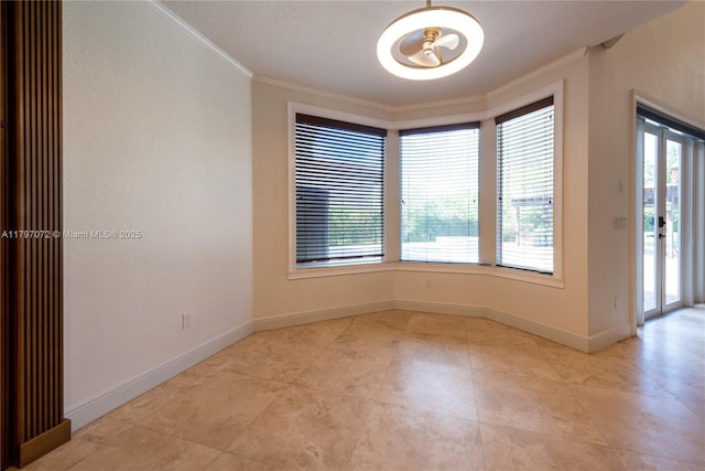 empty room with crown molding, baseboards, and an inviting chandelier