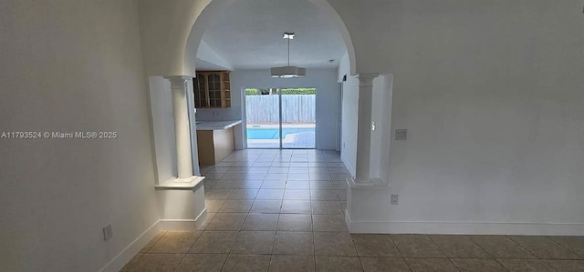 14661 SW 50th St, Miami, FL 33175 - hall with tile patterned floors, baseboards, ornate columns, and arched walkways