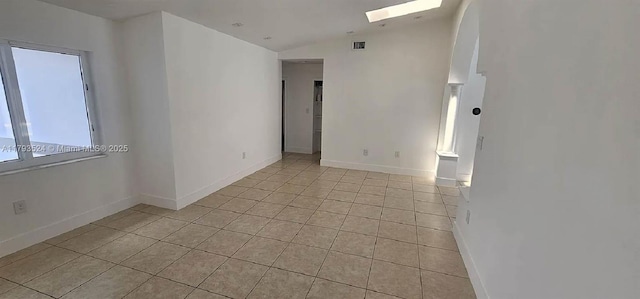 14661 SW 50th St, Miami, FL 33175 - empty room featuring visible vents, baseboards, light tile patterned flooring, and lofted ceiling with skylight
