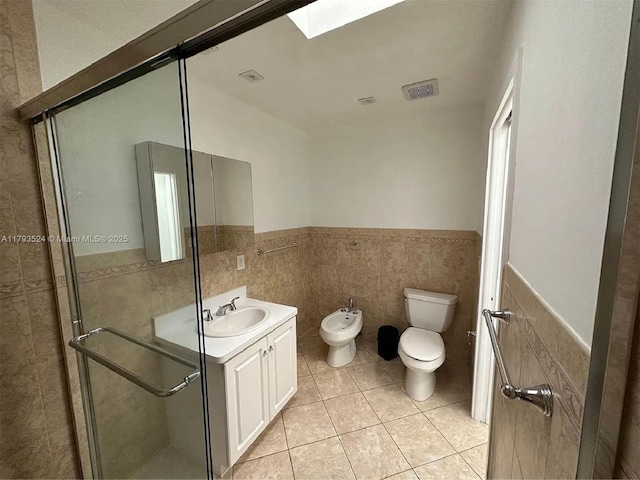 14661 SW 50th St, Miami, FL 33175 - full bathroom featuring toilet, a bidet, vanity, tile patterned flooring, and wainscoting
