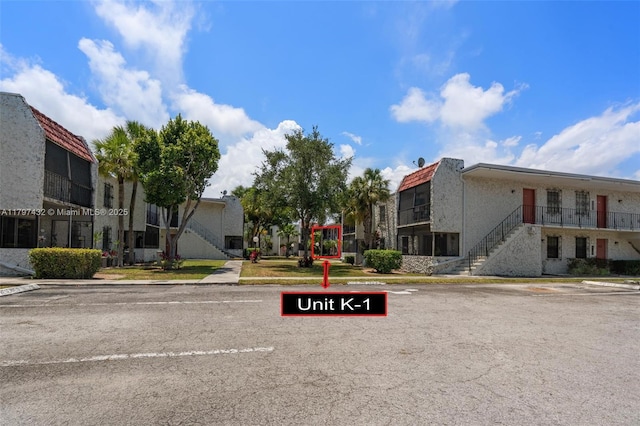 view of street with sidewalks, curbs, and stairs