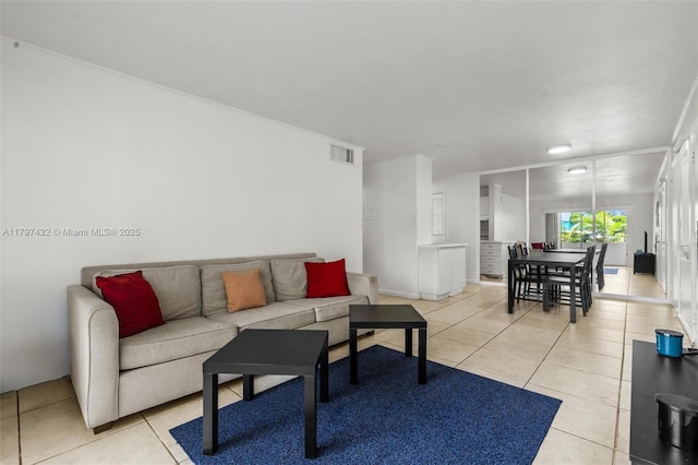 living area with light tile patterned floors and visible vents