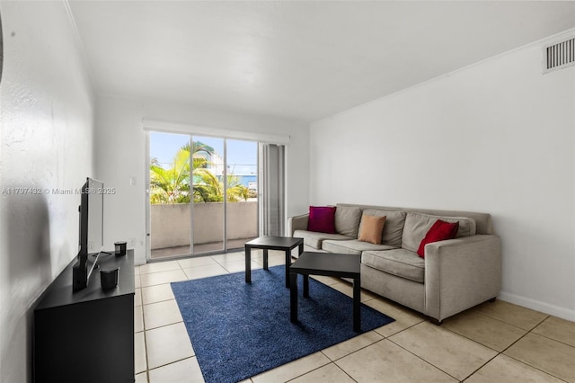 living area featuring baseboards, light tile patterned floors, and visible vents