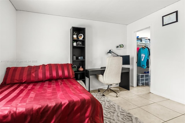 bedroom with tile patterned floors and baseboards