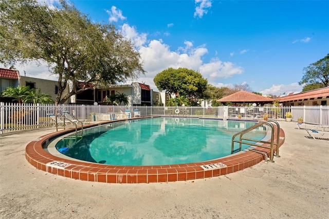 pool featuring a patio and fence