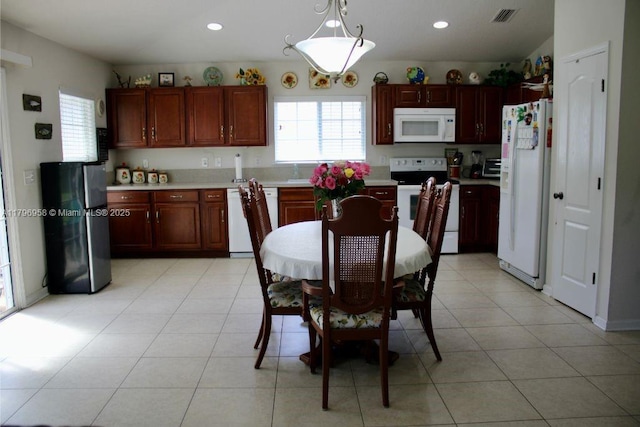 kitchen featuring white appliances, a healthy amount of sunlight, light countertops, and visible vents