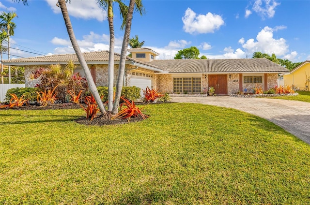 1243 Funston St, Hollywood, FL 33019 - view of front of property featuring driveway, a tiled roof, a garage, stucco siding, and a front lawn