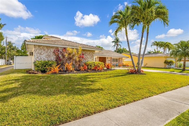 1243 Funston St, Hollywood, FL 33019 - ranch-style home with stucco siding, concrete driveway, a front lawn, and a tiled roof