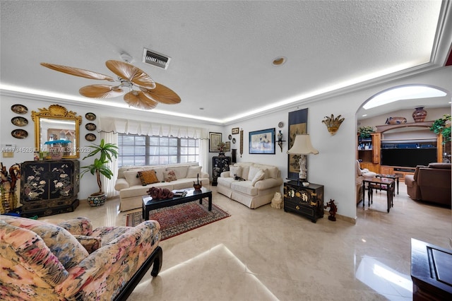 1243 Funston St, Hollywood, FL 33019 - living area with arched walkways, a ceiling fan, visible vents, and a textured ceiling