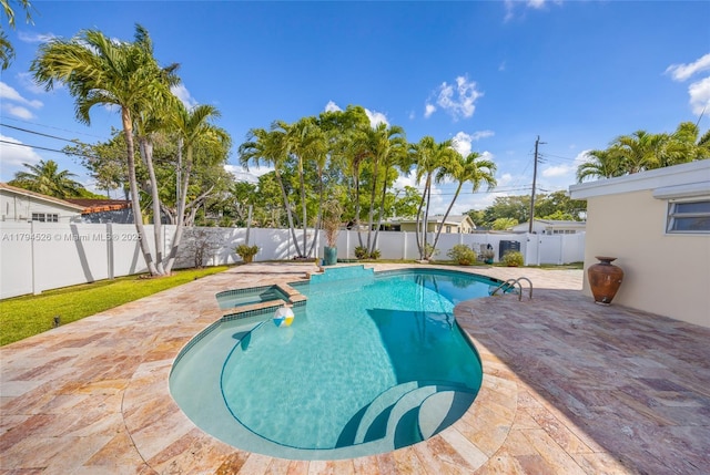 1243 Funston St, Hollywood, FL 33019 - view of swimming pool featuring a fenced backyard, a patio area, and a pool with connected hot tub