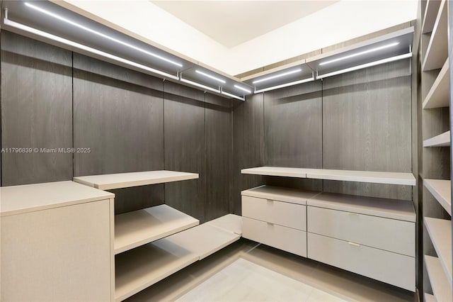 spacious closet featuring tile patterned flooring