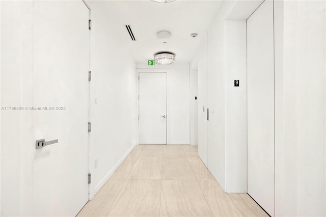 corridor with light tile patterned floors and visible vents
