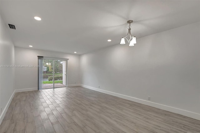 spare room with baseboards, recessed lighting, visible vents, and wood finished floors
