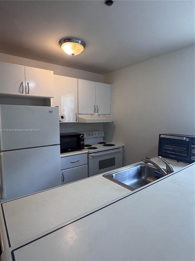 361 Collins Ave Unit A2, Miami Beach, FL 33139 - kitchen featuring under cabinet range hood, white appliances, a sink, light countertops, and white cabinets